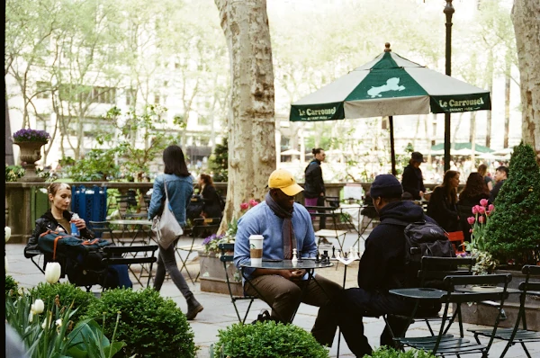 Bryant Park NYC on a sunny day with people relaxing in the green space
