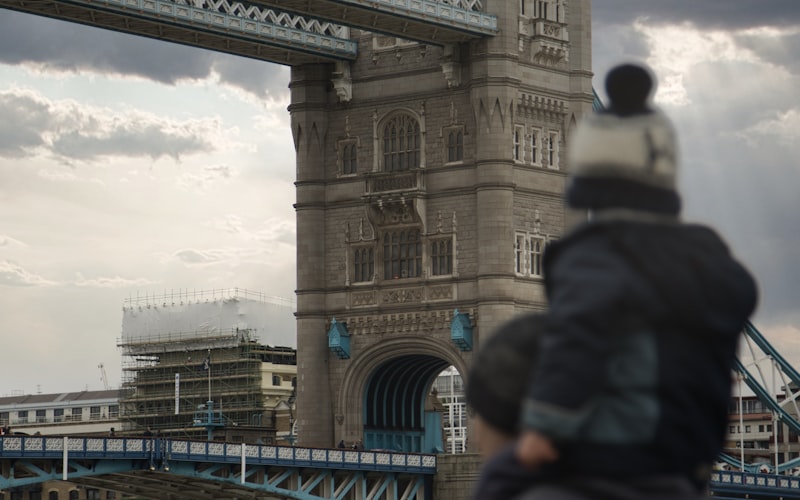 Turista frente al Tower Bridge, icono del itinerario turístico de Londres para familias