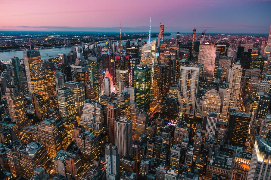 Manhattan illuminated at night – Boroughs of New York City skyline view
