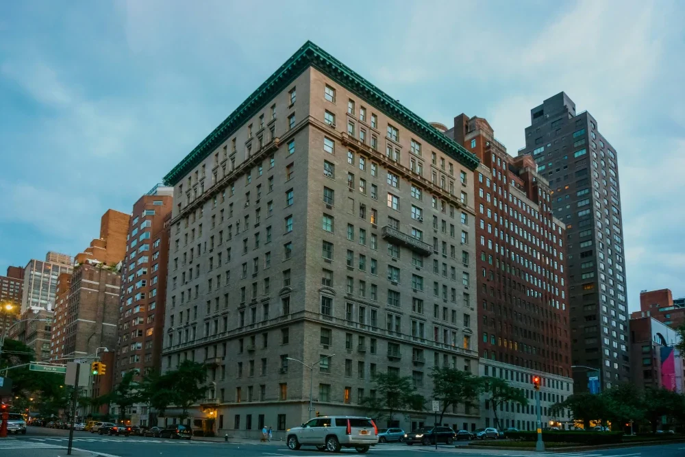 Facade of Park Avenue building at East 72nd Street, New York City, with urban skyline overhead.