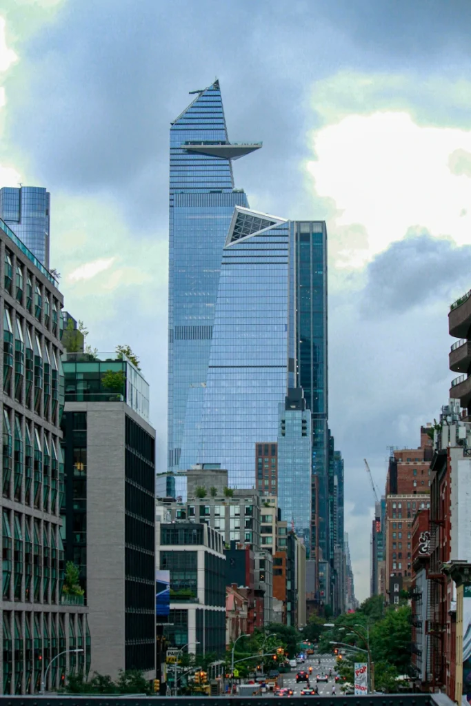 The Edge building in NYC as seen from Tenth Avenue, surrounded by iconic skyscrapers