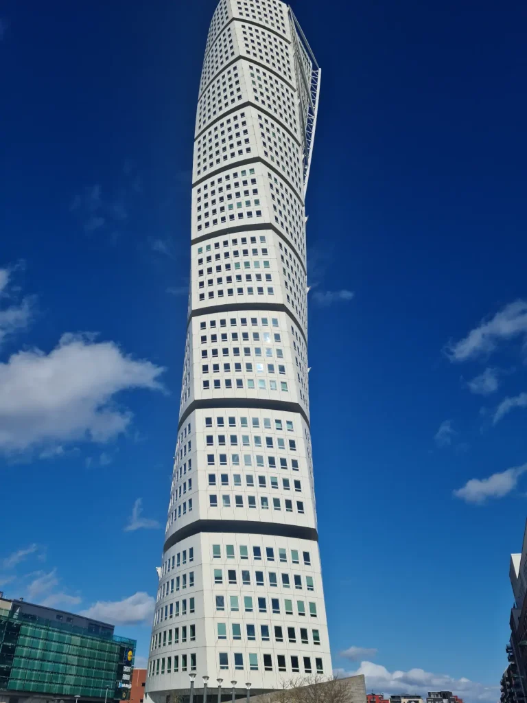 Turning Torso, a spiral skyscraper in Malmö with a clear blue sky in the background.