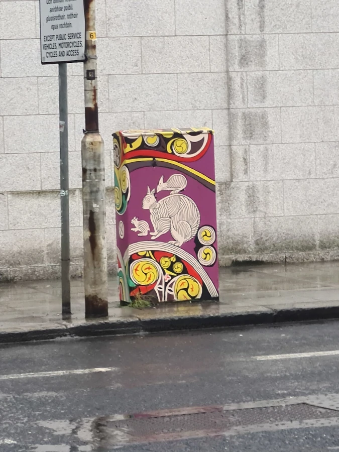 Utility box decorated with colorful street art